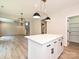 Kitchen island featuring white cabinets, a white countertop, and modern lighting fixtures at 2387 Trundle Dr # Cwo0155, Gastonia, NC 28054