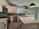 Well-equipped kitchen showcasing stainless steel appliances, a quartz countertop island, and tiled backsplash at 2387 Trundle Dr # Cwo0155, Gastonia, NC 28054