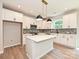 Modern kitchen with white cabinets, a kitchen island, stainless steel appliances, and stylish light fixtures at 2387 Trundle Dr # Cwo0155, Gastonia, NC 28054