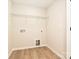 Empty laundry room featuring wood floors, a wire rack shelf, and connections for washer and dryer at 2387 Trundle Dr # Cwo0155, Gastonia, NC 28054