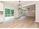 Open concept living room and kitchen with deck access, hardwood floors, and modern lighting at 2387 Trundle Dr # Cwo0155, Gastonia, NC 28054