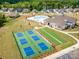 Aerial view of community with pool, clubhouse, and pickleball courts at 3118 Whispering Creek Dr # 188, Indian Trail, NC 28079