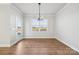 Bright dining room features hardwood floors, chandelier, and door to patio at 3118 Whispering Creek Dr # 188, Indian Trail, NC 28079