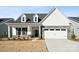 Craftsman style home with gray stone accents and a covered porch at 3118 Whispering Creek Dr, Indian Trail, NC 28079