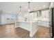 Modern kitchen with white cabinets, quartz countertops, and island at 3118 Whispering Creek Dr # 188, Indian Trail, NC 28079