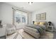 Bedroom with large window providing natural light, a comfy chair, and stylish decor at 3118 Whispering Creek Dr, Indian Trail, NC 28079