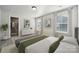 Bedroom featuring natural light, white walls, walk-in closet, and modern decor at 3118 Whispering Creek Dr, Indian Trail, NC 28079