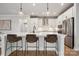 Bright, modern kitchen with a large island, pendant lighting, and stainless steel appliances at 3118 Whispering Creek Dr, Indian Trail, NC 28079