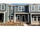 New construction townhome with gray siding, brick accents and a covered entryway at 115 Ciara Pl # B, Mooresville, NC 28117