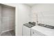 Convenient laundry room with modern washer and dryer next to shelving and white walls at 115 Ciara Pl # B, Mooresville, NC 28117