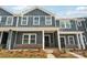 Charming gray townhome featuring a welcoming porch and well-maintained landscaping, creating a cozy curb appeal at 115 Ciara Pl # C, Mooresville, NC 28117