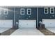 Attached garages with white doors, offering convenience and additional storage at 115 Ciara Pl # C, Mooresville, NC 28117