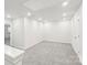 Spacious loft area with gray carpeting and two doors at 115 Ciara Pl # C, Mooresville, NC 28117