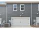 Garage with white door and grey siding at 115 Ciara Pl # D, Mooresville, NC 28117