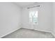 Simple bedroom with grey carpet and a window with curtains at 2608 Grantham Place Dr, Fort Mill, SC 29715