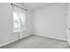 Bright bedroom with grey carpeting and a large window at 2608 Grantham Place Dr, Fort Mill, SC 29715