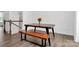 Simple dining area with wooden table and bench near staircase at 2608 Grantham Place Dr, Fort Mill, SC 29715