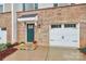 Townhome's front entrance with teal door and attached garage at 2608 Grantham Place Dr, Fort Mill, SC 29715