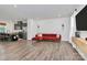 Open living room with red sectional sofa and hardwood floors at 2608 Grantham Place Dr, Fort Mill, SC 29715