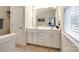 Double vanity bathroom with a large mirror and window at 786 Petersburg Dr, Fort Mill, SC 29708