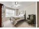 Bedroom with a striped comforter and an accent chair at 786 Petersburg Dr, Fort Mill, SC 29708