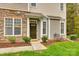 Inviting front entry with stone accents and a charming dark brown door at 786 Petersburg Dr, Fort Mill, SC 29708