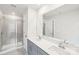 Double vanity bathroom with grey cabinets and a shower at 115 Ciara Pl # A, Mooresville, NC 28117