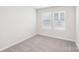 Simple bedroom with grey carpet and two windows at 115 Ciara Pl # A, Mooresville, NC 28117