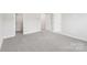Spacious bedroom with grey carpet and mirrored closet at 115 Ciara Pl # A, Mooresville, NC 28117