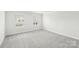 Bright bedroom with grey carpet and two large windows at 115 Ciara Pl # A, Mooresville, NC 28117