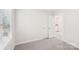 Bedroom with grey carpet, window, and laundry access at 115 Ciara Pl # A, Mooresville, NC 28117