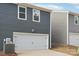 Attached garage with white door and AC unit at 115 Ciara Pl # A, Mooresville, NC 28117