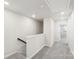 Upstairs hallway with grey carpet and access to bedrooms at 115 Ciara Pl # A, Mooresville, NC 28117