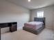 Bedroom with gray platform bed, desk, and carpeted floor at 13905 Castle Nook Dr, Charlotte, NC 28273