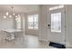 Bright dining room with marble table, modern chandelier, and entryway view at 13905 Castle Nook Dr, Charlotte, NC 28273