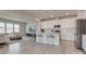 Open concept kitchen with white cabinets, stainless steel appliances, and an island at 13905 Castle Nook Dr, Charlotte, NC 28273