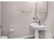 Powder room features a pedestal sink, neutral paint, and chrome fixtures at 18023 Train Station Dr, Cornelius, NC 28031