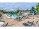 Community pool with lounge chairs, umbrellas, and a playground at 18023 Train Station Dr, Cornelius, NC 28031