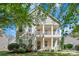 Charming two-story home featuring a double front porch and beautifully landscaped front yard at 18023 Train Station Dr, Cornelius, NC 28031