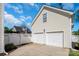 Attached two-car garage with white doors and siding at 18023 Train Station Dr, Cornelius, NC 28031