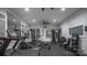 Well-equipped gym with modern exercise machines, mirrored wall, and ceiling fan at 18023 Train Station Dr, Cornelius, NC 28031