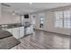 A kitchen featuring stainless steel appliances, white cabinets, granite countertops and wood-look flooring at 18023 Train Station Dr, Cornelius, NC 28031