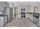 Modern kitchen featuring stainless steel appliances, gray cabinets and granite countertops at 18023 Train Station Dr, Cornelius, NC 28031