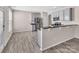 Kitchen featuring stainless steel appliances, gray cabinets, and wood-look flooring at 18023 Train Station Dr, Cornelius, NC 28031