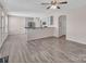 Open concept living room/kitchen with wood-look floors and neutral paint at 18023 Train Station Dr, Cornelius, NC 28031
