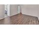 Large bedroom featuring hardwood flooring, natural light, and access to en suite bathroom at 18023 Train Station Dr, Cornelius, NC 28031