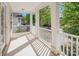 Covered porch with white railings, columns, and tile flooring at 18023 Train Station Dr, Cornelius, NC 28031