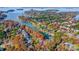 Stunning aerial view of a waterfront community showcasing fall foliage and lake access at 20361 Enclave Oaks Ct, Cornelius, NC 28031