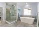 Bathroom featuring a modern soaking tub, a glass shower, and sleek fixtures at 20361 Enclave Oaks Ct, Cornelius, NC 28031