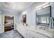 Elegant bathroom boasts double vanity with marble countertop and modern fixtures at 20361 Enclave Oaks Ct, Cornelius, NC 28031